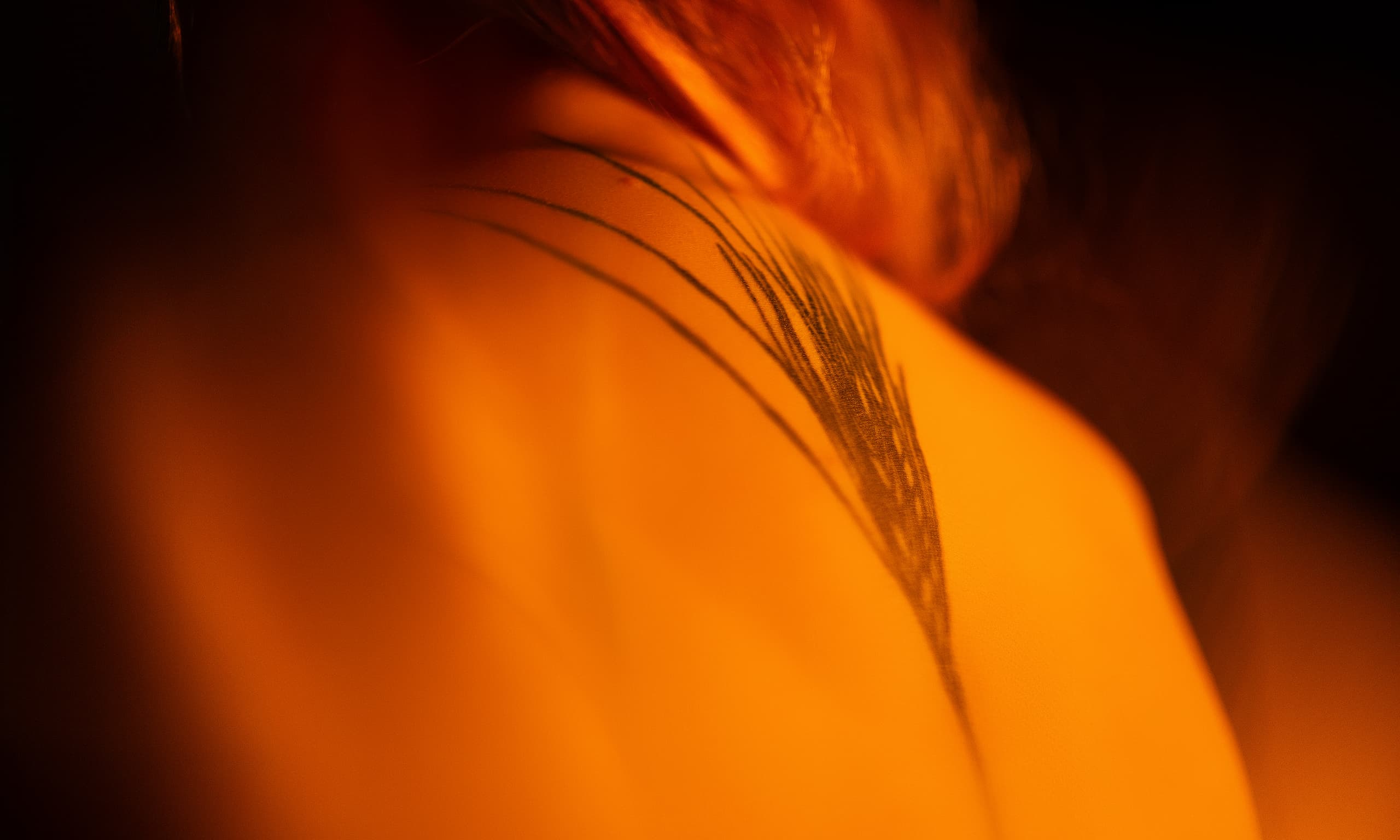 Woman with tattoos during a boudoir photography session in Denver, Colorado